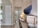 Bright hallway with modern decor, leading to a luxury bathroom with a glass shower at 706 Manns Harbor Dr, Apollo Beach, FL 33572