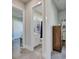 Bright hallway with views of a bathroom and living spaces, and decorative furnishings at 706 Manns Harbor Dr, Apollo Beach, FL 33572