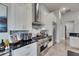Kitchen with stainless steel appliances, modern backsplash, and white cabinets for a sleek look at 706 Manns Harbor Dr, Apollo Beach, FL 33572