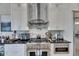 Close-up of modern kitchen featuring stainless steel appliances and a sleek backsplash design at 706 Manns Harbor Dr, Apollo Beach, FL 33572