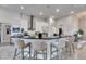 Modern kitchen featuring a large island with seating, stainless steel appliances, and stylish backsplash at 706 Manns Harbor Dr, Apollo Beach, FL 33572