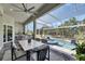 Screened-in lanai featuring an outdoor kitchen, dining area, and luxurious swimming pool at 706 Manns Harbor Dr, Apollo Beach, FL 33572