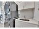 Functional laundry room featuring stackable washer and dryer and quartz countertop at 706 Manns Harbor Dr, Apollo Beach, FL 33572