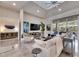 Bright living room with high ceilings, tile flooring, comfortable seating, and access to the outdoor area at 706 Manns Harbor Dr, Apollo Beach, FL 33572