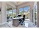 Bright home office with large windows, a view of the lanai, and a spacious desk for productivity at 706 Manns Harbor Dr, Apollo Beach, FL 33572