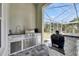 Well-equipped outdoor kitchen with stainless steel appliances and bar area at 706 Manns Harbor Dr, Apollo Beach, FL 33572