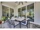 Outdoor patio with a six person dining table and three panel sliding glass doors at 706 Manns Harbor Dr, Apollo Beach, FL 33572