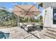 Covered patio with lounge seating under a large umbrella, offering a relaxing outdoor experience at 706 Manns Harbor Dr, Apollo Beach, FL 33572