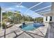 Backyard swimming pool and spa area with stylish patio furniture at 706 Manns Harbor Dr, Apollo Beach, FL 33572