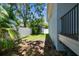 Fenced backyard with tropical landscaping and a shed at 7113 S Mascotte St, Tampa, FL 33616