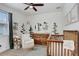 Cozy Bedroom featuring a crib, dresser, and comfortable seating at 7113 S Mascotte St, Tampa, FL 33616