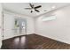 Light-filled bedroom with private balcony, dark wood floors, and modern design at 7113 S Mascotte St, Tampa, FL 33616