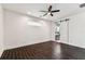 Bright bedroom features dark wood floors, large window, and barn door to ensuite at 7113 S Mascotte St, Tampa, FL 33616