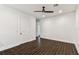 Spacious bedroom with dark wood floors, white walls, and modern ceiling fan at 7113 S Mascotte St, Tampa, FL 33616