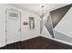 Stylish entryway boasts a modern light fixture, unique wall design, and dark wood-look floors at 7113 S Mascotte St, Tampa, FL 33616