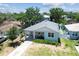 Charming home with a well-maintained yard, inviting curb appeal, and a long driveway, aerial view at 7113 S Mascotte St, Tampa, FL 33616