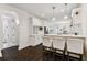 A modern kitchen features a breakfast bar, stainless appliances, and white cabinets at 7113 S Mascotte St, Tampa, FL 33616