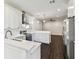 An eat-in kitchen features bright white cabinets, stainless steel appliances, and sleek countertops at 7113 S Mascotte St, Tampa, FL 33616