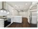 This open concept kitchen boasts stainless steel appliances, white cabinetry, and sleek countertops at 7113 S Mascotte St, Tampa, FL 33616