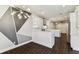 Open-concept kitchen features white cabinetry, modern appliances, and stylish geometric wall art at 7113 S Mascotte St, Tampa, FL 33616