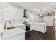 This gorgeous kitchen features white cabinets, stainless steel appliances, and sleek countertops at 7113 S Mascotte St, Tampa, FL 33616