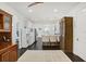 Open kitchen with white cabinets, dark wood floors, and a breakfast bar with seating at 7113 S Mascotte St, Tampa, FL 33616