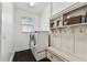 Well-organized laundry room with washer, dryer, and storage at 7113 S Mascotte St, Tampa, FL 33616