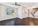 Bright living room features modern lighting, fresh white paint, and dark brown flooring at 7113 S Mascotte St, Tampa, FL 33616