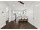 Open-concept living room and kitchen with dark wood floors and white cabinets at 7113 S Mascotte St, Tampa, FL 33616