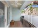 Charming covered patio with wood flooring and a ceiling fan at 7113 S Mascotte St, Tampa, FL 33616
