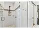 Modern shower with glass door, white tile, and sleek fixtures at 7113 S Mascotte St, Tampa, FL 33616