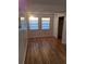 Bedroom featuring wood floors, multiple windows, and a closet with ample sunlight at 754 71St N Ave, St Petersburg, FL 33702
