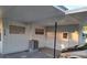 Carport showcasing a car, siding, two small horizontal windows, and exterior access door at 754 71St N Ave, St Petersburg, FL 33702
