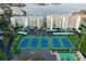 Aerial view of community with tennis courts, shuffleboard, and waterfront apartments at 7872 Sailboat Key S Blvd # 404, South Pasadena, FL 33707
