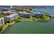 Drone image showing lakefront condos with pool and shoreline views at 7872 Sailboat Key S Blvd # 404, South Pasadena, FL 33707