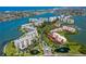 Aerial shot of condo building and surrounding waterways, showing tennis courts, docks, and boat slips at 7872 Sailboat Key S Blvd # 404, South Pasadena, FL 33707