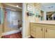 Bathroom with tiled shower, neutral-toned vanity with marble countertop, and access to a closet at 7872 Sailboat Key S Blvd # 404, South Pasadena, FL 33707