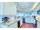 Bright kitchen with stainless steel appliances, granite countertops and wine storage at 7872 Sailboat Key S Blvd # 404, South Pasadena, FL 33707