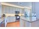 Well-lit kitchen with wooden floors, stainless steel appliances, and a granite countertop island at 7872 Sailboat Key S Blvd # 404, South Pasadena, FL 33707