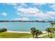 Scenic view of the bay featuring the city skyline, palm trees, and sandy shoreline at 7872 Sailboat Key S Blvd # 404, South Pasadena, FL 33707
