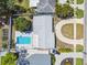 A top-down view of the home with pool, circular driveway, mature trees, and street access at 827 Virginia St, Dunedin, FL 34698
