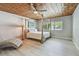 Bedroom with four-poster bed, wood paneled ceiling, and an inviting chaise lounge at 827 Virginia St, Dunedin, FL 34698