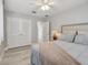 Bedroom featuring hardwood floors, a ceiling fan, and double closets at 827 Virginia St, Dunedin, FL 34698
