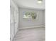 Bright bedroom with neutral walls, white trim, and wood-look floors at 827 Virginia St, Dunedin, FL 34698