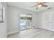 Bedroom with sliding doors that offer access to the screened patio and pool at 827 Virginia St, Dunedin, FL 34698