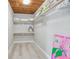 Walk-in closet with wood ceiling, shelving, and ample storage space for clothes and accessories at 827 Virginia St, Dunedin, FL 34698
