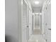 Hallway with white doors and access to multiple rooms at 827 Virginia St, Dunedin, FL 34698