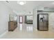 Open-concept living area featuring a red door, gray sofa, and modern decor at 827 Virginia St, Dunedin, FL 34698