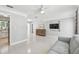 Bright living room featuring a sofa, tv and an opening to the kitchen at 827 Virginia St, Dunedin, FL 34698