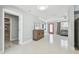 Open-concept living area featuring bright white walls and a red front door at 827 Virginia St, Dunedin, FL 34698